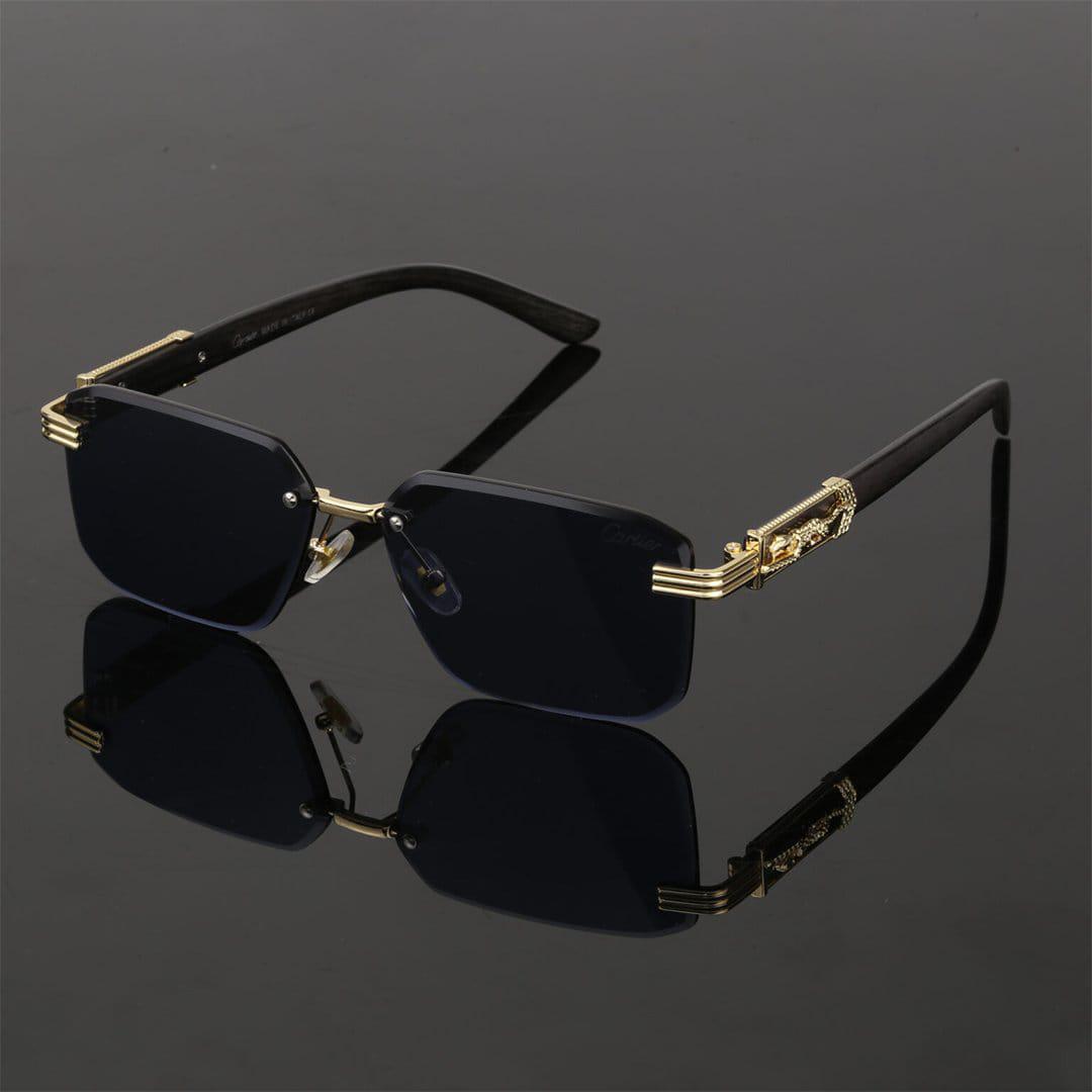Black and gold stylish sunglasses with square lenses on a reflective black surface